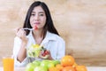 Healthy food concept. woman having breakfast with salad vegetarian looking at camera. Smiling girl eating fresh Royalty Free Stock Photo