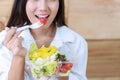 Healthy food concept. woman having breakfast with salad vegetarian. Smiling girl eating fresh salad for health Royalty Free Stock Photo
