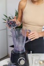 Healthy food concept. Close up of woman prepare to blending berries to make smoothie at home kitchen Royalty Free Stock Photo