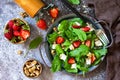 Healthy food concept, Diet salad plate. Summer salad with strawberries, fetacheese and walnut Royalty Free Stock Photo