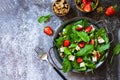 Healthy food concept, Diet salad plate. Summer salad with strawberries, fetacheese and walnut on a stone countertop. Royalty Free Stock Photo