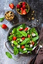 Healthy food concept, Diet salad plate. Summer salad with strawberries, fetacheese and walnut Royalty Free Stock Photo