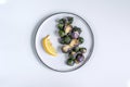 Healthy food concept, dieting, vegetarian, vegan - organic purple brussel sprouts fried on plate with lemon, top view