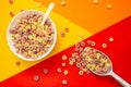 Healthy food concept, Fruit ring cereals in bowl and cereals in ice scoop on colorful background Royalty Free Stock Photo