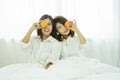 Healthy food concept. Happy two young woman holding fresh oranges fruit covered their one eyes. Cheerful two friend or sister Royalty Free Stock Photo