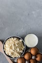 Healthy food concept, homemade cottage cheese, a glass of milk, yogurt and chicken eggs on a stone background, dairy products on d Royalty Free Stock Photo