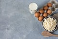 Healthy food concept, homemade cottage cheese, a glass of milk, yogurt and chicken eggs on a stone background, dairy products on d Royalty Free Stock Photo