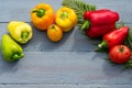 Healthy food concept. Natural organic vegetables bell peppers red, yellow, green and tomatoes on a wooden blue background in a Royalty Free Stock Photo