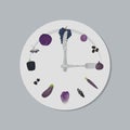 Healthy food concept. Plate with purple vegetables and fruits, knife and fork in shape of clock hands Royalty Free Stock Photo