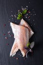 Healthy Food concept top view raw fillets Alaska Pollock, Black Cod on black slate stone board with copy space Royalty Free Stock Photo