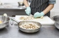 Woman in gloves cutting mushrooms for cooking tasty home food