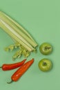 Healthy Food Concepts. Upper View Flatlay of Variety of Fresh Fruits and Vegetables Placed on Trendy Green Background