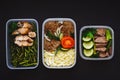 The healthy food in the containers on black background: snack, dinner, lunch. Baked fish, beans, beef cutlets, mashed potatoes, me Royalty Free Stock Photo