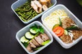 The healthy food in the containers on black background: snack, dinner, lunch. Baked fish, beans, beef cutlets, mashed potatoes, me Royalty Free Stock Photo