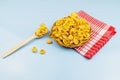 Healthy food cornflakes in wicker bowl with wooden spoon on red towel