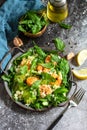 Couscous salad with arugula, avocado and grilled shrimps