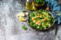 Healthy food. Dieting dinner. Couscous salad with arugula, avocado and grilled shrimps.