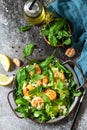 Healthy food. Dieting dinner. Couscous salad with arugula, avocado and grilled shrimps.