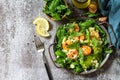 Healthy food. Dieting dinner. Couscous salad with arugula, avocado and grilled shrimps. Top view flat lay background.