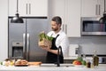 Healthy food for dinner. Man cooking home food. Healthy food, cooking concept. Mature man in apron choose ingredient Royalty Free Stock Photo