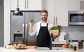 Healthy food for dinner. Man cooking home food. Healthy food, cooking concept. Mature man in apron choose ingredient Royalty Free Stock Photo