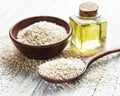 Sesame oil and seeds on a rustic table Royalty Free Stock Photo