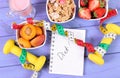 Healthy food, dumbbells, tape measure and notebook for notes. Slimming, healthy and sporty lifestyle Royalty Free Stock Photo