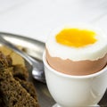 Healthy food. English breakfast with boiled egg and croutons on a white wood background