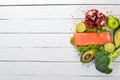 Healthy food. Fish salmon, avocado, broccoli, fresh vegetables, nuts and fruits. On a white wooden background. Royalty Free Stock Photo