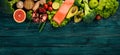 Healthy food. Fish salmon, avocado, broccoli, fresh vegetables, nuts and fruits. On a wooden background. Royalty Free Stock Photo