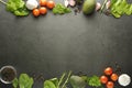 Healthy food frame mockup. Dark background with copy space with spices, vegetables - avocado, spinach, tomatoes. Flat lay