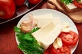 Healthy food - fresh bread and feta cheese on a wooden background, tomatoes, greens and vegetables Royalty Free Stock Photo