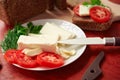 Healthy food - fresh bread and feta cheese on a wooden background, tomatoes, greens and vegetables Royalty Free Stock Photo