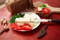 Healthy food - fresh bread and feta cheese on a wooden background, tomatoes, greens and vegetables Royalty Free Stock Photo