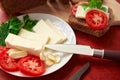 Healthy food - fresh bread and feta cheese on a wooden background, tomatoes, greens and vegetables Royalty Free Stock Photo