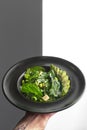 Healthy food. Fresh green salad on a black plate. Healthy vegetarian lunch.