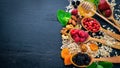 Healthy food. Fresh wild berries, copper, nuts, oatmeal, dried fruits and seeds. On a wooden background. Top view. Royalty Free Stock Photo