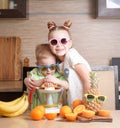 Healthy food: a girl and a boy make fresh orange juice. Royalty Free Stock Photo