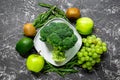 healthy food with green vegetables, fruits for dinner on dark table background top view Royalty Free Stock Photo