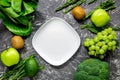 Healthy food with green vegetables, fruits for dinner on dark table background top view mock-up Royalty Free Stock Photo