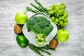 Healthy food with green vegetables, fruits for dinner on gray table background top view Royalty Free Stock Photo