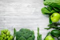 Healthy food with green vegetables, fruits for dinner on gray table background top view mock up Royalty Free Stock Photo