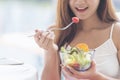 Healthy food healthy lifestyle with young happy woman eating green fresh ingredients organic salad. Vegan girl holding salad bowl Royalty Free Stock Photo