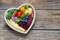 Healthy food in heart diet cooking concept with fresh fruits and vegetables Royalty Free Stock Photo