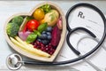 Healthy food in heart stethoscope and medical prescription diet and medicine concept Royalty Free Stock Photo