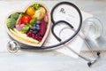 Healthy food in heart stethoscope and medical prescription diet and medicine concept