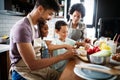 Happy family in the kitchen having fun and cooking together. Healthy food at home. Royalty Free Stock Photo