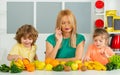 Healthy food at home. Happy family in the kitchen. Mother and children are preparing the vegetables and fruit. Healthy Royalty Free Stock Photo