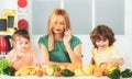 Healthy food at home. Happy family in the kitchen. Mother and children are preparing the vegetables and fruit. Healthy Royalty Free Stock Photo