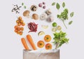 Healthy food ingredients. Fresh vegetables with herbs and spices spilled out of shopping paper bag Royalty Free Stock Photo
